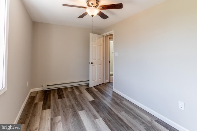 unfurnished room with dark wood-type flooring, a baseboard radiator, and ceiling fan