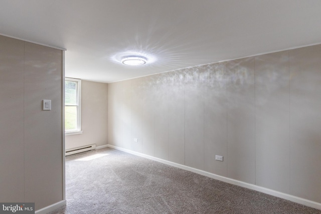 carpeted empty room featuring a baseboard heating unit