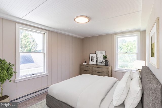 bedroom with a baseboard radiator and wood walls