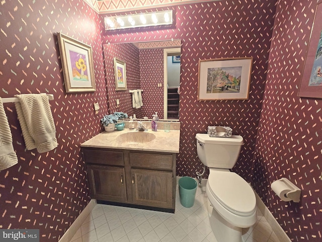 bathroom featuring tile patterned flooring, vanity, and toilet