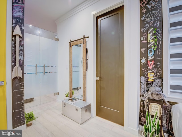 bathroom with hardwood / wood-style flooring and crown molding