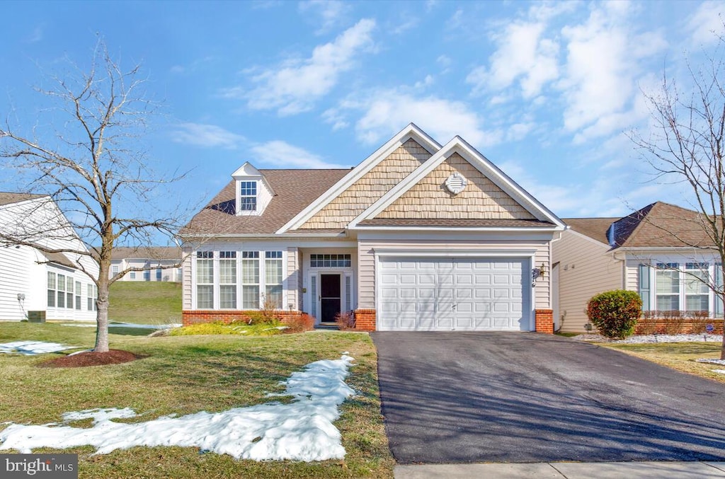 view of front of house with a garage and a front yard