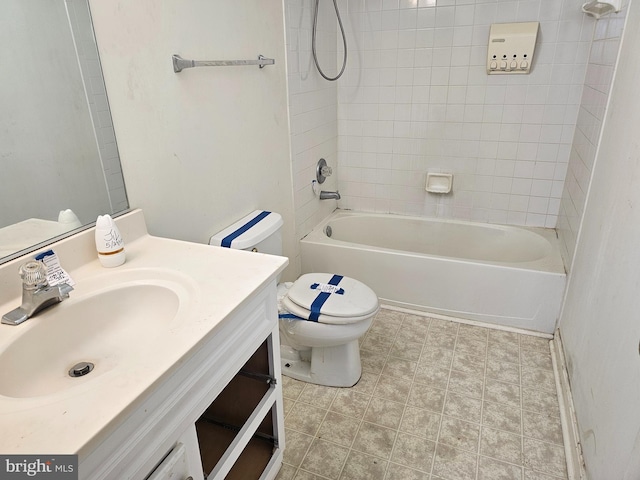 full bathroom featuring tiled shower / bath combo, vanity, and toilet