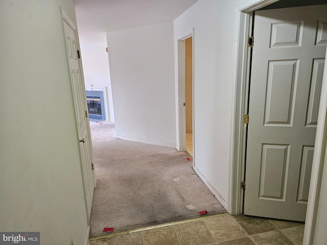 corridor featuring light colored carpet