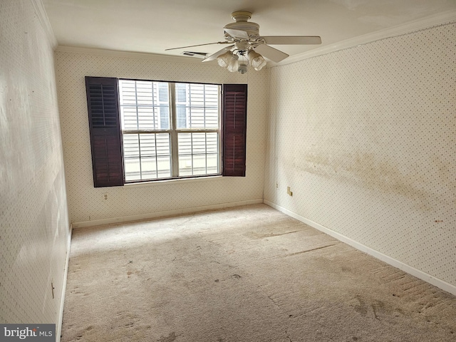 carpeted empty room featuring ornamental molding and ceiling fan