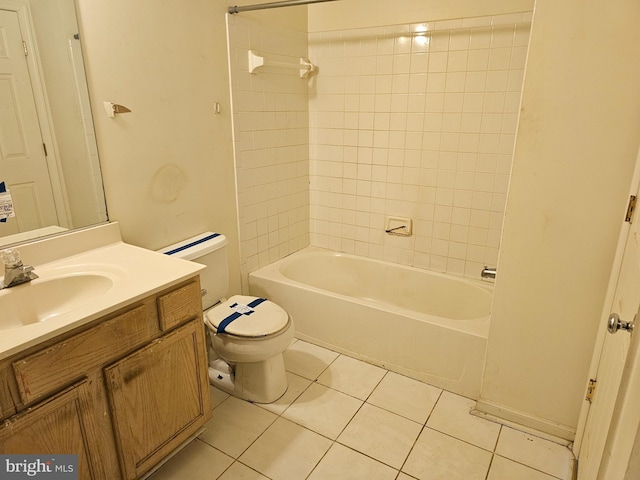 full bathroom featuring tiled shower / bath combo, vanity, tile patterned floors, and toilet