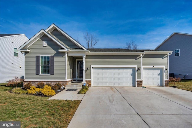 view of front of house featuring a garage and a front lawn