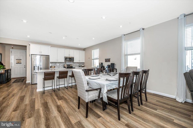 dining area with a healthy amount of sunlight and hardwood / wood-style floors