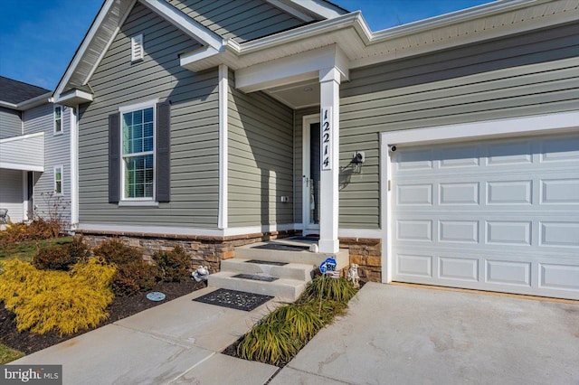 doorway to property with a garage