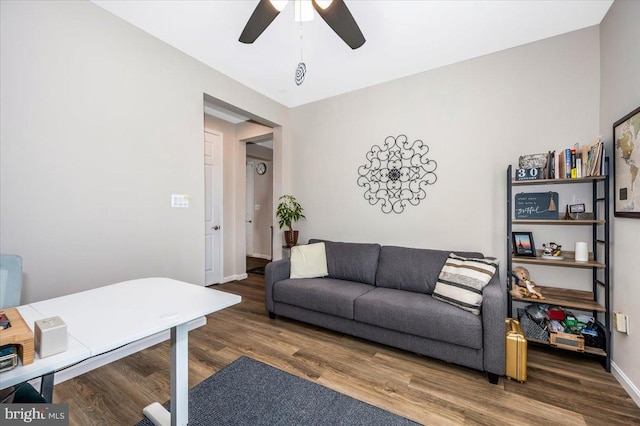 living room with dark hardwood / wood-style flooring and ceiling fan