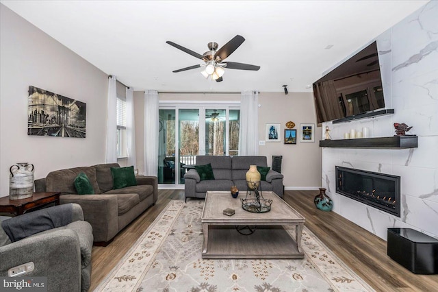 living room with hardwood / wood-style floors and ceiling fan