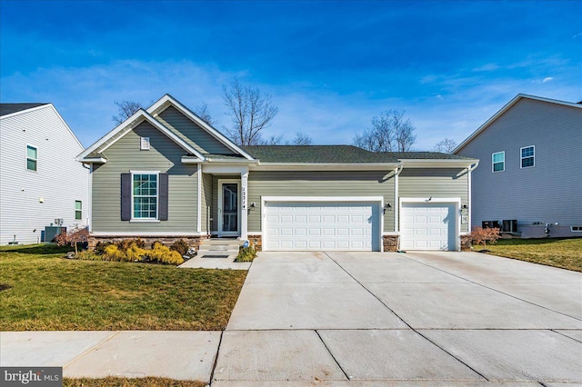 view of front of home featuring a garage, central AC, and a front yard