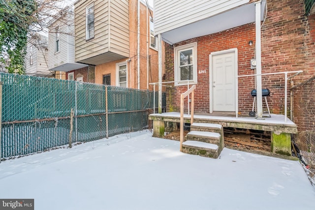 view of snow covered property entrance