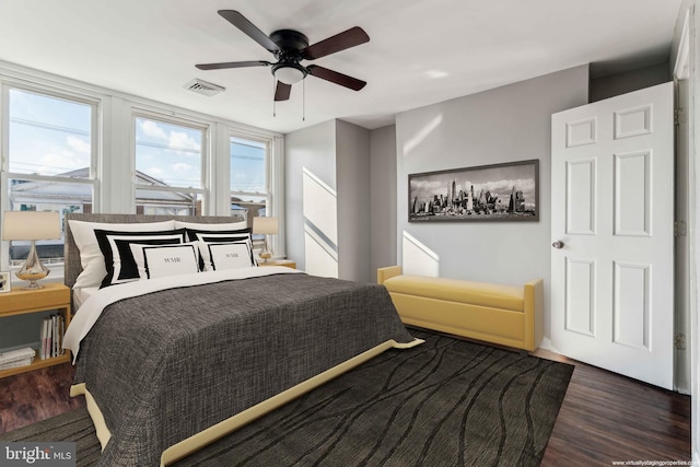 bedroom with dark hardwood / wood-style floors and ceiling fan