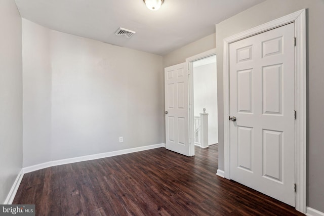 unfurnished bedroom featuring dark hardwood / wood-style flooring