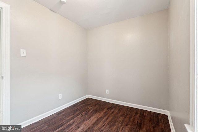 unfurnished room with dark hardwood / wood-style floors