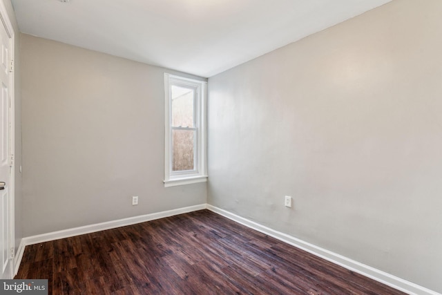 spare room featuring dark hardwood / wood-style flooring