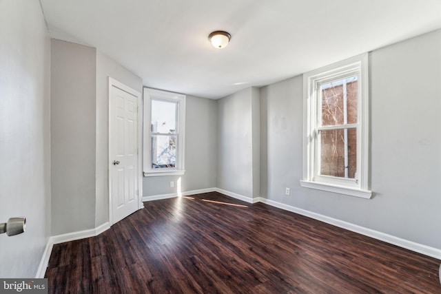 empty room featuring dark hardwood / wood-style flooring