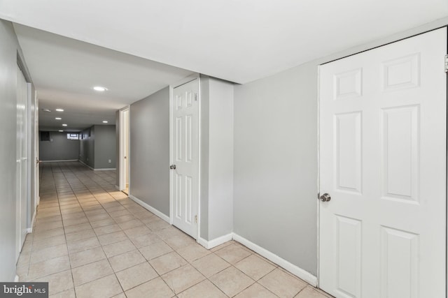 hall featuring light tile patterned flooring