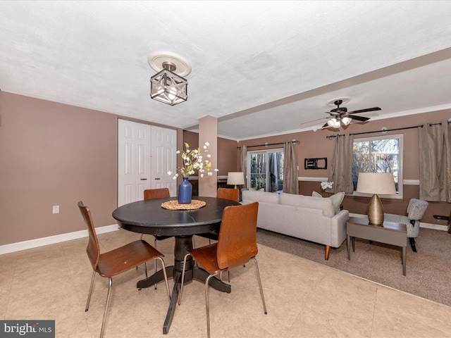 dining space with crown molding and light tile patterned floors