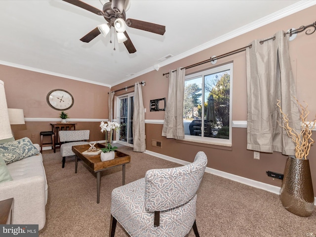 living room featuring crown molding, ceiling fan, and carpet flooring