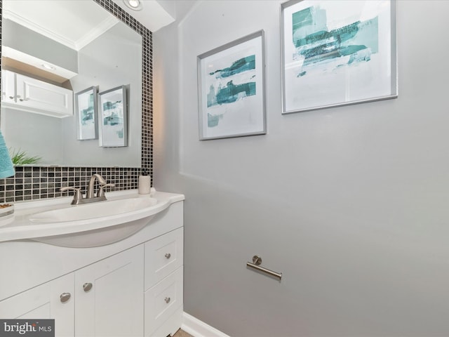 bathroom with vanity, decorative backsplash, and ornamental molding