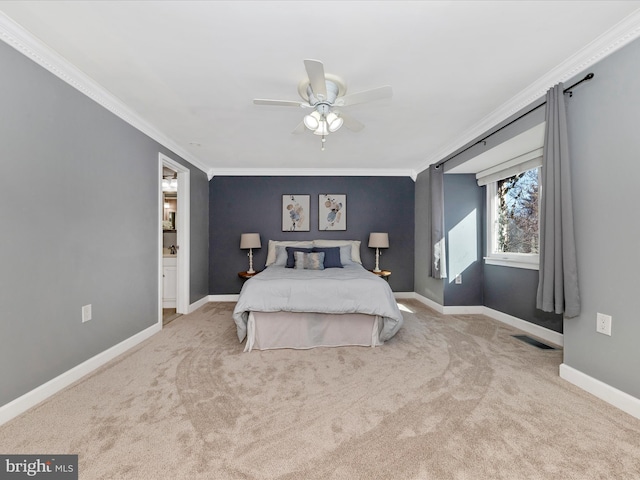 carpeted bedroom featuring crown molding, ensuite bathroom, and ceiling fan