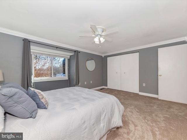 bedroom with ornamental molding, light colored carpet, ceiling fan, and a closet