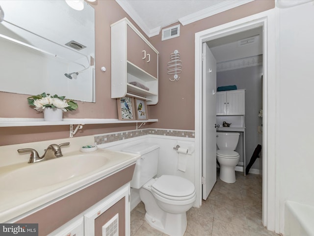 bathroom with crown molding, vanity, toilet, and tile patterned flooring