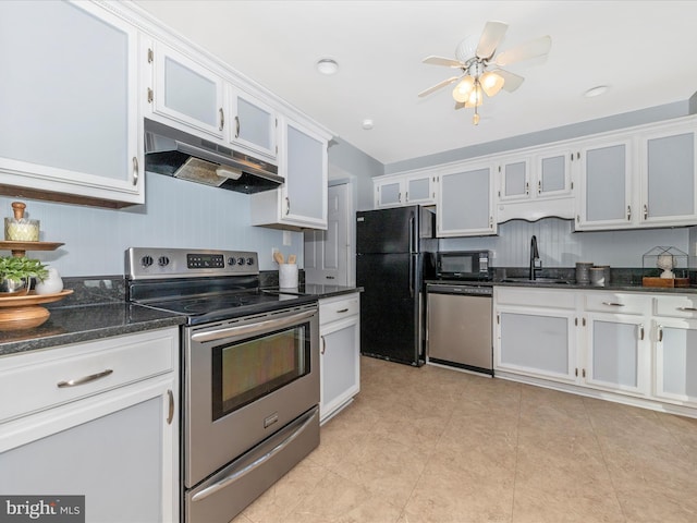 kitchen with sink, ceiling fan, white cabinetry, black appliances, and dark stone counters