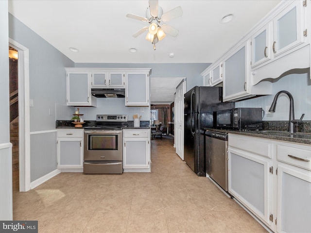 kitchen with sink, ceiling fan, appliances with stainless steel finishes, dark stone countertops, and white cabinets