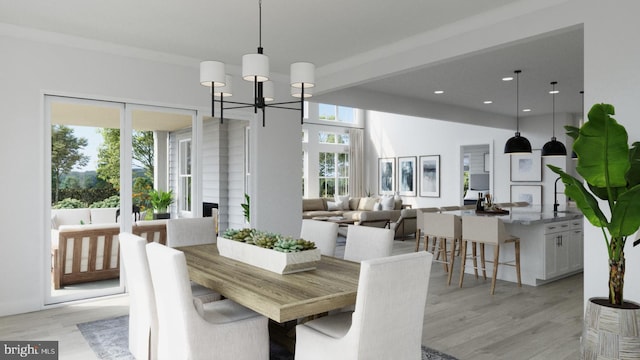 dining space featuring a notable chandelier and light wood-type flooring