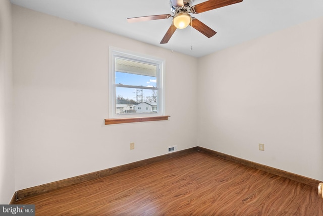 spare room featuring hardwood / wood-style floors and ceiling fan