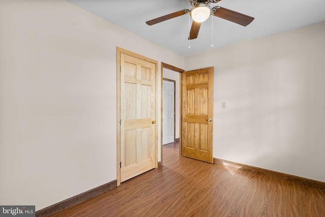 unfurnished bedroom featuring ceiling fan and hardwood / wood-style floors