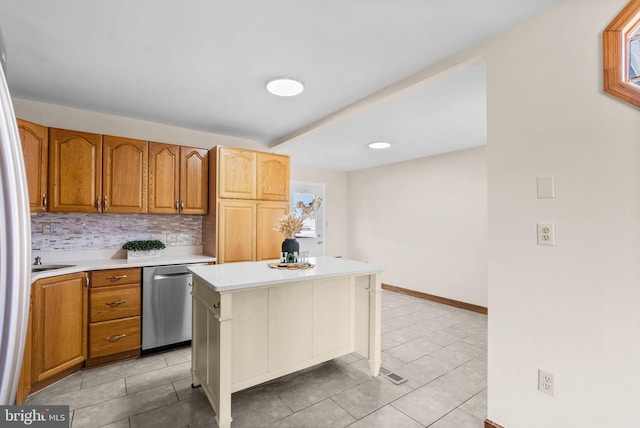 kitchen featuring light tile patterned flooring, a kitchen island, tasteful backsplash, dishwasher, and a kitchen breakfast bar