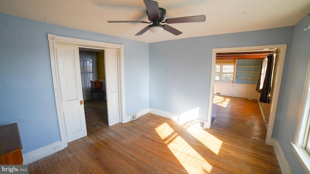 empty room featuring wood-type flooring and ceiling fan