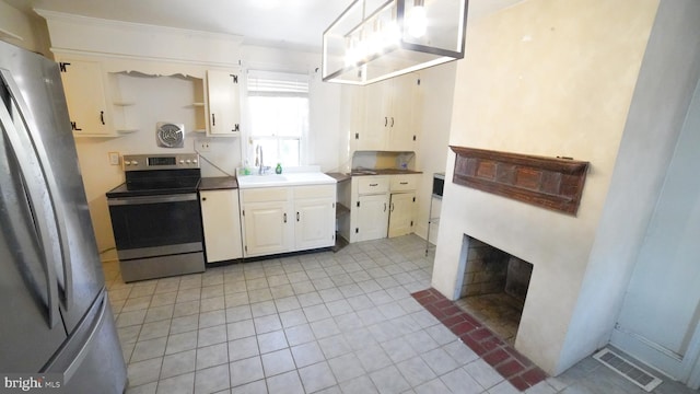 kitchen with stainless steel appliances, ornamental molding, and sink