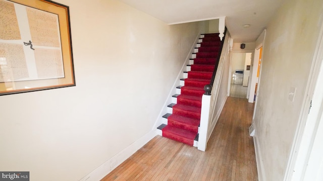 stairs with hardwood / wood-style floors