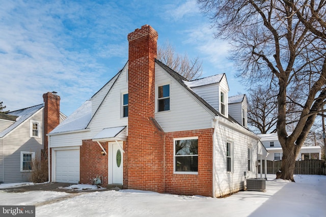 exterior space with a garage and central air condition unit