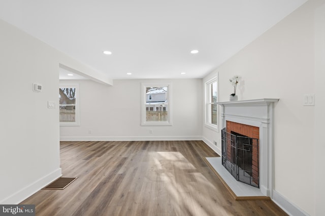 unfurnished living room featuring beam ceiling and hardwood / wood-style floors