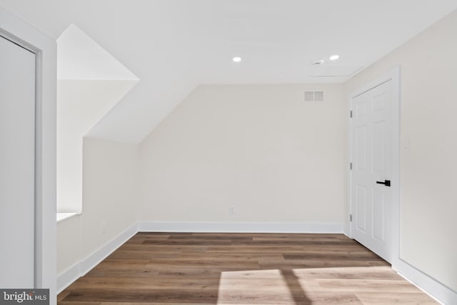 bonus room featuring wood-type flooring and vaulted ceiling