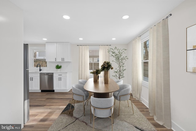 dining space with dark wood-type flooring and sink