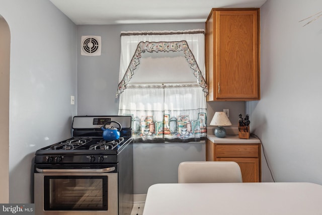 kitchen with stainless steel gas range oven