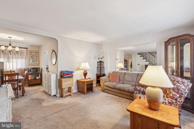 living room with light colored carpet and a chandelier