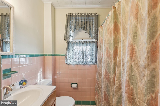 bathroom featuring tile walls, vanity, ornamental molding, curtained shower, and toilet