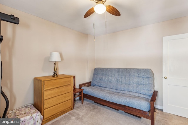 living area with ceiling fan and light colored carpet