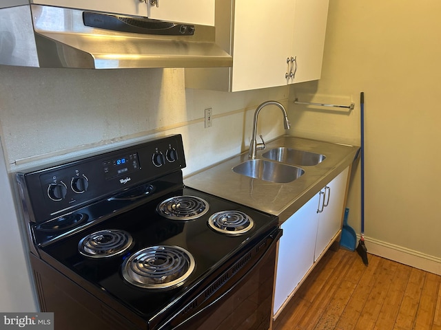 kitchen featuring sink, black electric range, hardwood / wood-style floors, and white cabinets