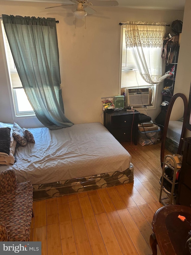 bedroom with ceiling fan and light hardwood / wood-style floors