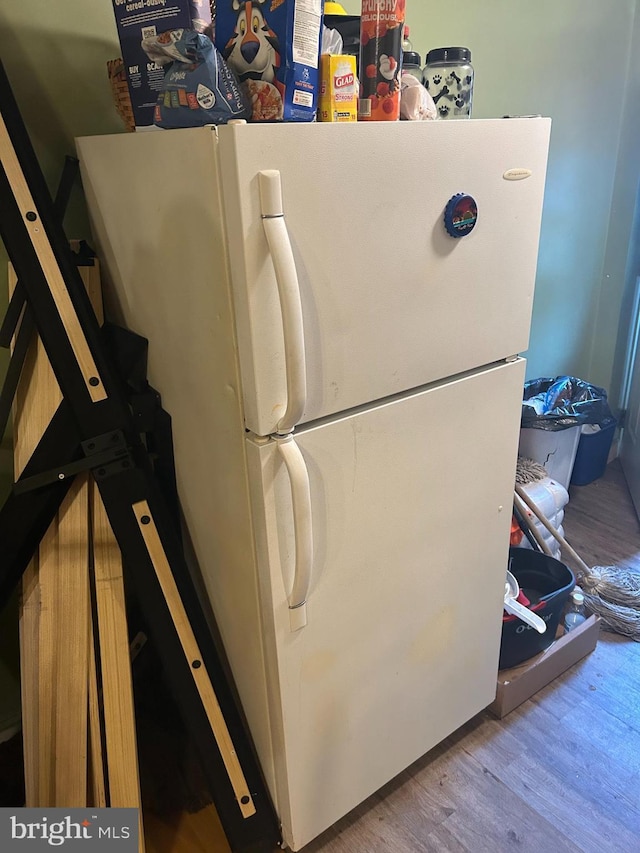 interior details with hardwood / wood-style flooring and white refrigerator