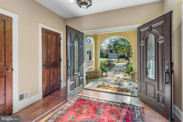 entryway with light tile patterned floors